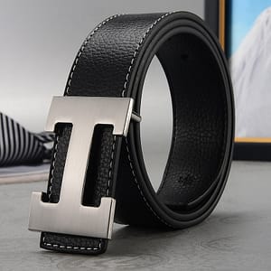 a black leather belt neatly rolled and laid on the floor
