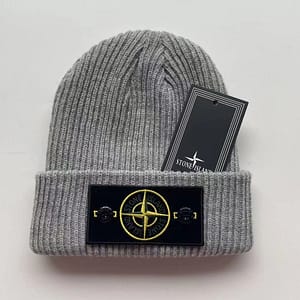 a gray winter hat laying on a white surface